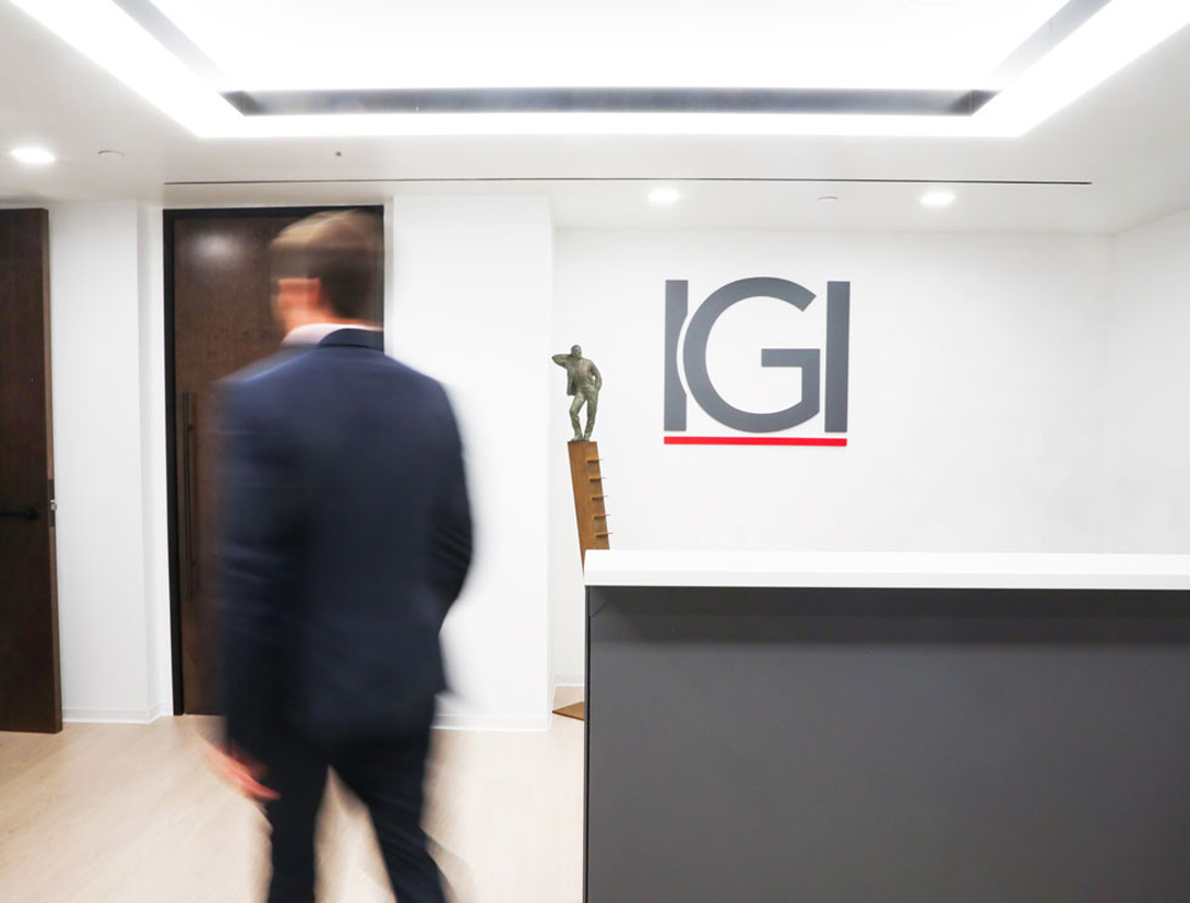 Blurry man from back walking through IGI reception area 